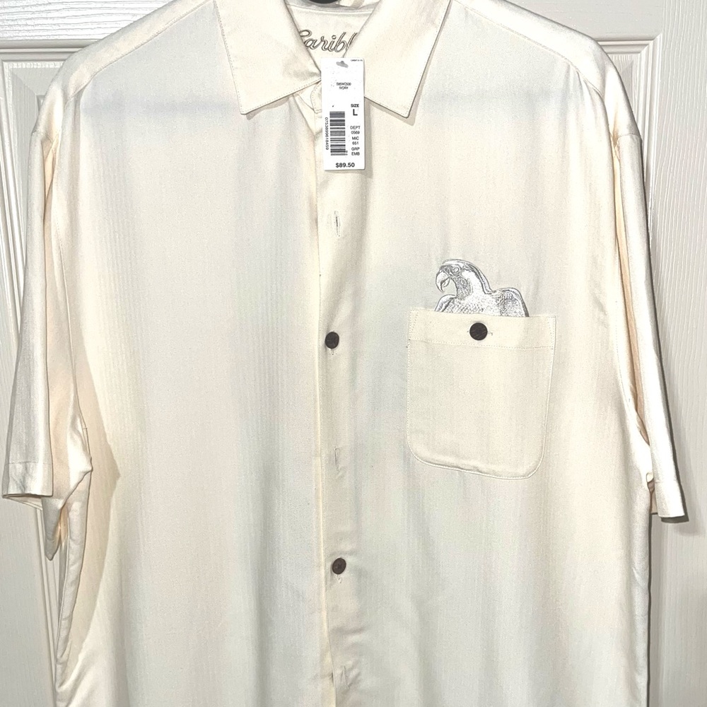 Size Large Caribbean brand tropical shirt. Shirt is 65% Rayon/35% Polyester.